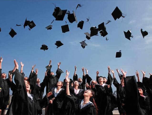 Graduates throwing caps in the air